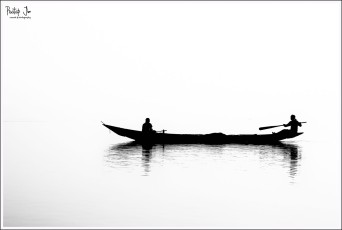 Two Men on a Small Boat in Chilka Lake in Orissa