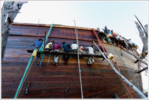 Workers building a wooden ship in Mandvi