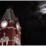 A full moon over the clock at Chennai Central Railway Station