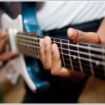 A photo of a man playing a guitar