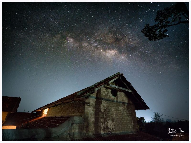Milky Way in the sky with a house in the foreground