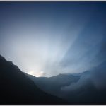 The sun rises from behind the mountains in the Himalayas on the Kuari Pass trek