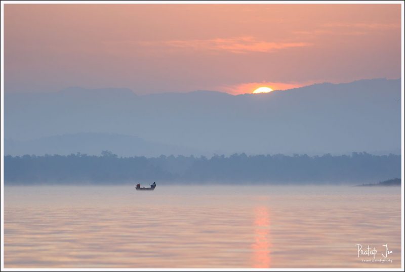 Two men fishing at sunrise