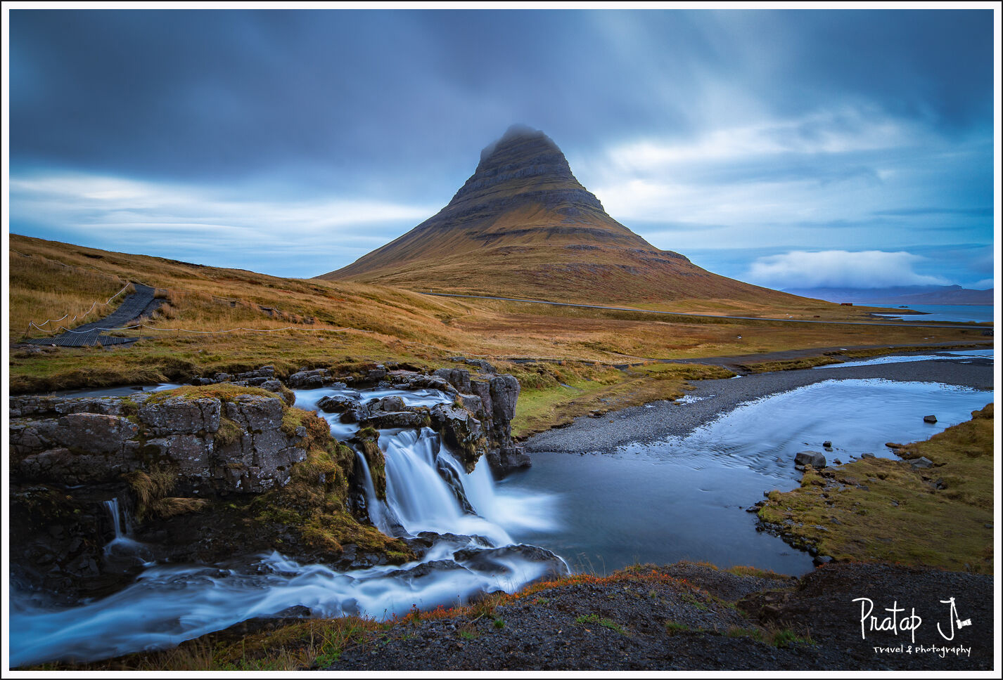 Kirkjufell and two waterfalls with grey skies