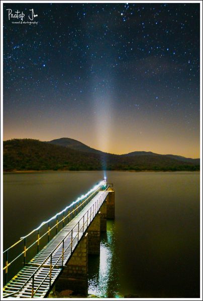 Composite of a Man Holding a Light Pointed to the Sky